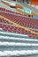 Empty seats in the stands of the arena or auditorium. Rows of red and white seats with no spectators. The concept of the abolition