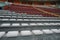 Empty seats in the stands of the arena or auditorium. Rows of red and white seats with no spectators. The concept of the abolition