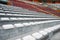 Empty seats in the stands of the arena or auditorium. Rows of red and white seats with no spectators. The concept of the abolition