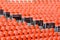 Empty seats. Tribune with orange chairs