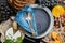 Empty serving blue plate with fork spoon in frame of food grocery ingredients Mediterranean Kitchen. Blue plate dish in frame of
