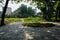 Empty shady flagstone paved ground before dwelling buildings in