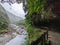 Empty Shakadang Trail crawls along cliffs and trees with Liwu River running on the side in a mist during the pandemic