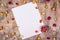Empty sheet of paper and rose. Rose on clean sheet. Dried rose and letter on wooden background. Copy space
