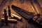 Empty shells from the rifle and combat knife lying on a wooden table.