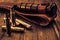 Empty shells from the rifle and leather sheath with combat knife lying on a wooden table.