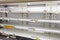 Empty shelves with groceries in supermarkets because of the pani