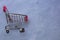 Empty shopping cart on blue concrete background