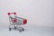 Empty shopping cart on concrete background. Soft focus