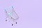 Empty shopping cart with light blue details on a pastel lilac background