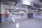 Empty shopping mall underground parking lot or garage interior with concrete stripe painted columns