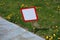 Empty sign on the lawn - white sign in red frame