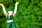Empty Silhouette of a girl that dress a green cap that dances  on Green Background with golden cascade of lights fot saint patrick