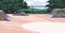 Empty skate park. Outdoor skatepark with graffiti on vert ramps, half-pipes. Modern skateboarding area landscape, place