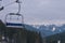 Empty ski chairlift with beautiful mountains forest on the background