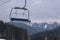 Empty ski chairlift with beautiful mountains forest on the background