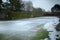 Empty small fenced grass field tennis courts in suburban area with snow in winter