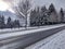 Empty, snowy road in front of a chain fence in the pacific northwest