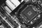 Empty socket Intel CPU on Gigabit motherboard, top view close-up, black and white photo
