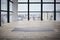 Empty space in fitness center, big windows, natural wooden floor, modern loft studio, unrolled yoga mat on the floor. no