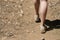 Empty space left close up of woman\'s feet hiking in dirt