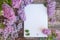 Empty space notepad list with lilac bunch flowers, cute spring banner mockup on a wooden backdrop