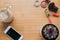 Empty space for text. Flat lay background with Phone, rouge, shadows, house plant, coffee on the table