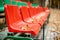 Empty sports grandstand in the leaves in the fall. Yellow leaves lie on a seat of a tribune