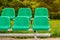 Empty sports stands with green seats