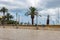 Empty square with palm trees and street lights in Bari, Italy. Italian architecture. Mediterranean landscape.