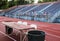 Empty stadium bleachers with table and chairs on track