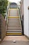 Empty stairs to British rural train station and waste beer can