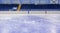 Empty stands of the ice arena and clean ice cut by skates.