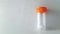 Empty sterile stool sample collection container with orange cap. Medical specimen jar for fecal analysis. Concept of