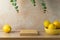 Empty stone podium on wooden table over modern background with eucalyptus leaves and lemons. Kitchen mock up for design and