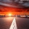 Empty straight road. Entry into the downtown at sunset