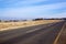 Empty Straight Rural Asphalt Road with Storage Silos