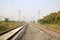 Empty straight single-way railways at summer sunny day