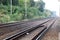 Empty straight single-way railways at summer sunny day