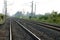 Empty straight single-way railways at summer sunny day