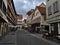 Empty street in the center of Esslingen with closed shops and people sitting in front of cafe on a sunday morning.