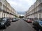 An empty street in London city with cars parked