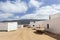 Empty street with sand and white houses in Caleta de Sebo on the island La Graciosa