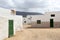 Empty street with sand and white houses in Caleta de Sebo on the island La Graciosa