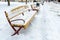 Empty streets without people after a snowfall. Empty park benches are covered in snow. Infrastructure is paralyzed due to a snow