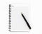 Empty stylish spiral Notepad for notes and a beautiful corporate pen on a white background. Empty space.