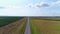 Empty suburban highway, aerial view. Road or freeway, green fields and meadows. Road background