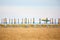 Empty sun lounges and closed parasols on the beach