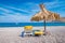 Empty sunbeds and umbrella on Vlycha beach near Lindos village