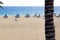 Empty sunbeds and umbrellas on beach in Puerto del Carmen, Lanzarote